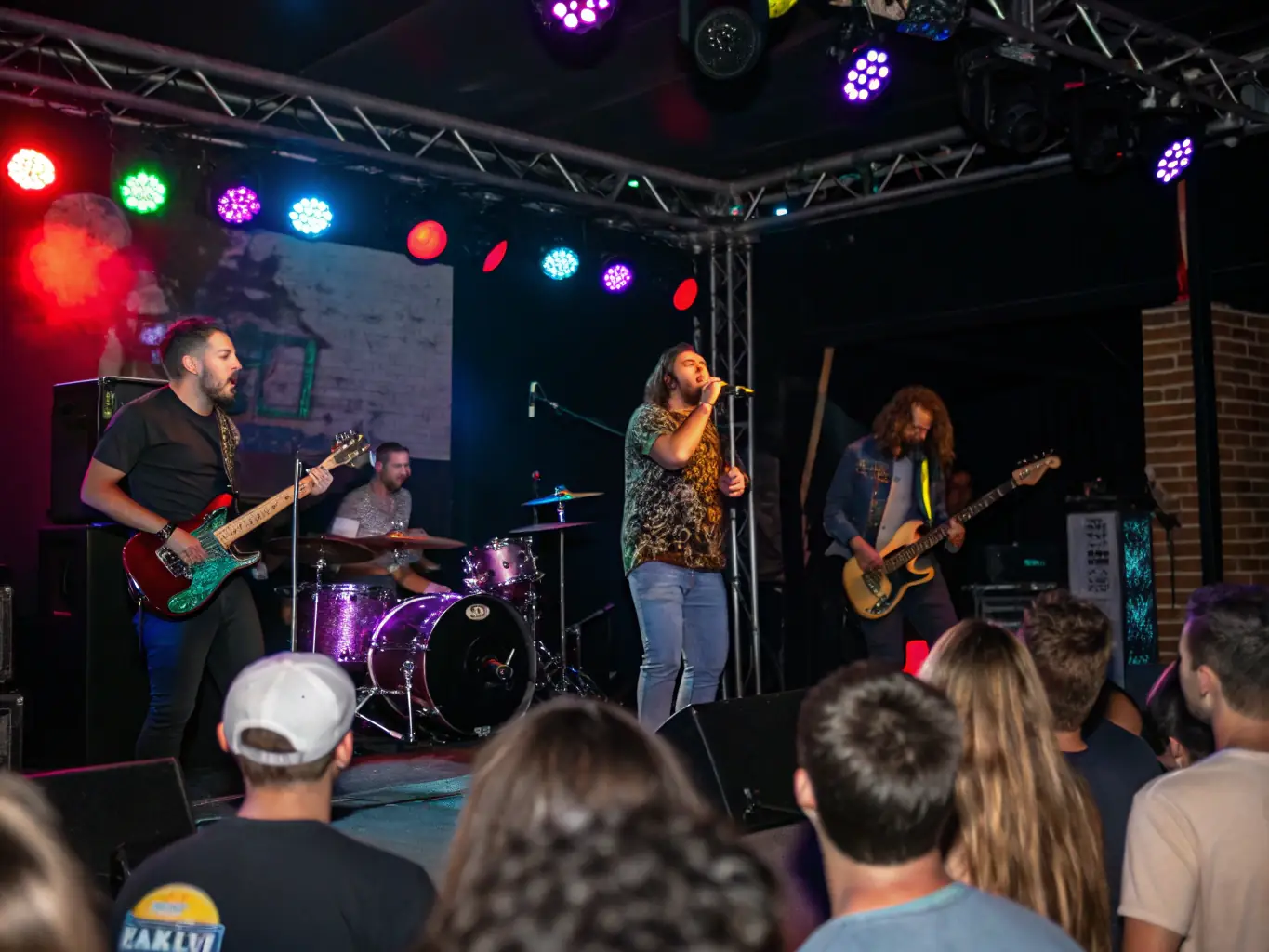 A vibrant image of a live concert organized by BALANCE ASSOCIATION, showcasing musicians on stage and an engaged audience, capturing the energy and excitement of the event.